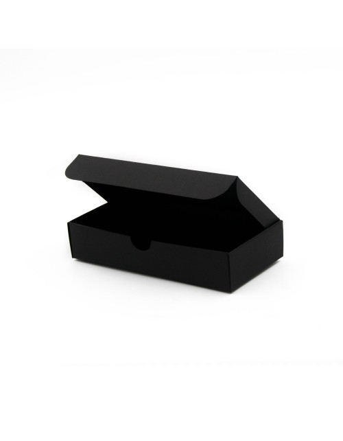 Pitkulainen musta laatikko kahdelle sylinterimäiselle kynttilälle