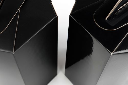 Two black boxes: one with a glossy finish, the other with a luxury matte laminate