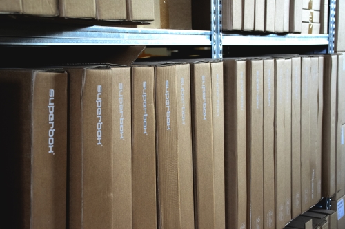 SUPERBOX cardboard packaging boxes used for shipping. The boxes are branded with company logos, ensuring sustainable and professional product delivery.