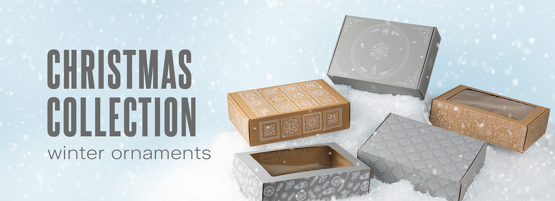 Five gift boxes on snow with a light blue background. On the left, the text ‘Christmas collection, winter ornaments’.